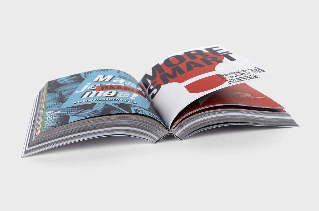 Het boek Two years of wemakethe.city - the festival that makes cities better opengeslagen op een kleurig geïllustreerde pagina.