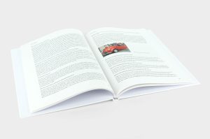 Het hardcover boek Opa vertelt opengeslagen op pagina's met tekst en een foto van een rode Citroën 2CV